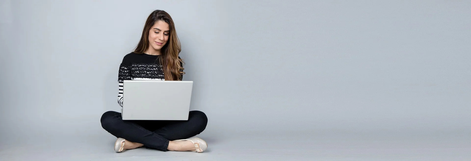 Girl smiling and using her laptop