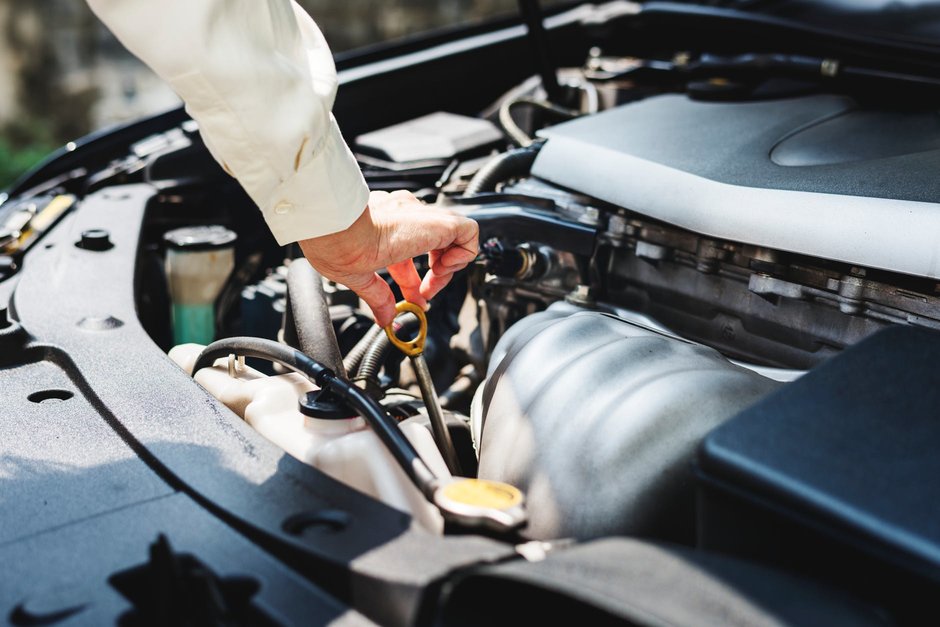 Engineer checking a car engine.