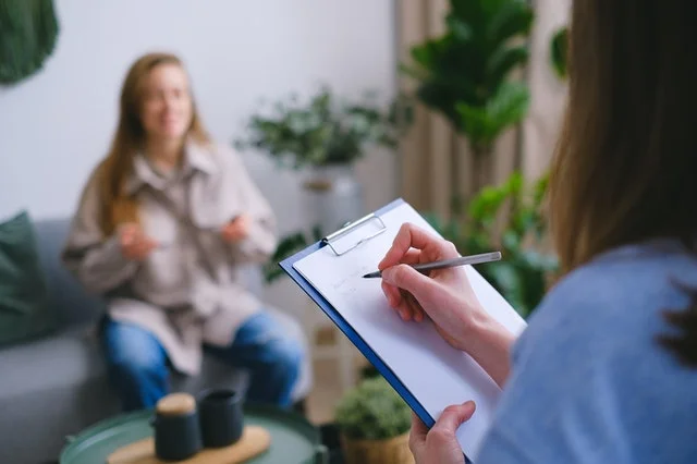 Psychologist holding notepad.