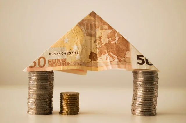 Bank note and coins on table.