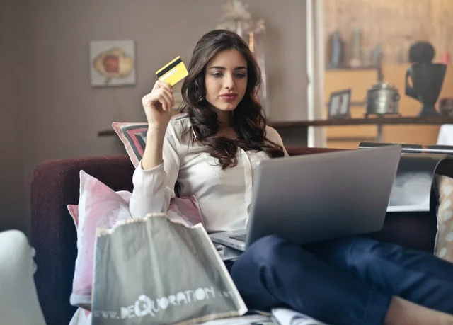 Student online shopping using her card.