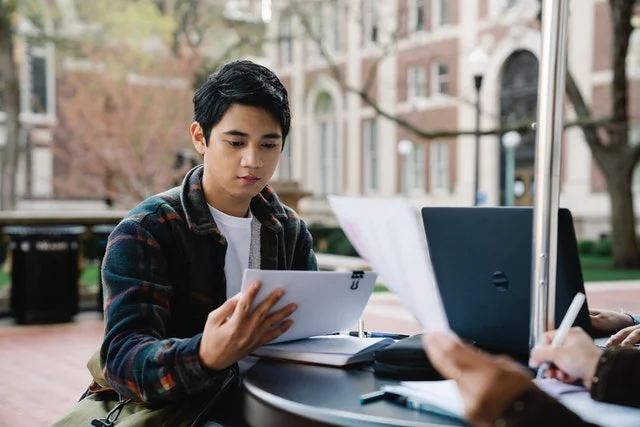 Male student working on assignment with extended deadline.