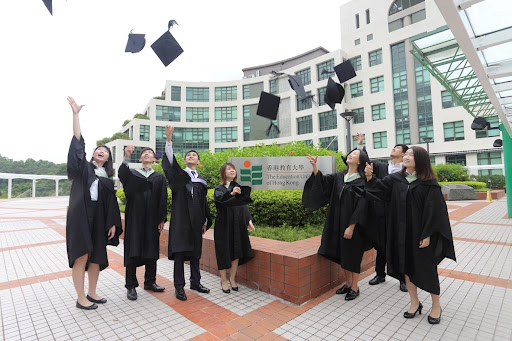 EdUHK graduates throwing their graduation caps in the air.
