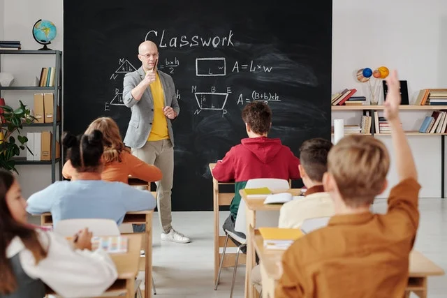 Male teacher in a classroom.