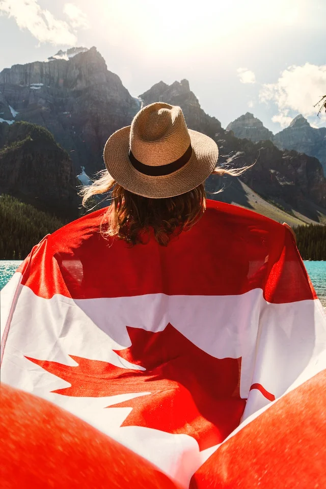 Honours degree student holding Canada flag.