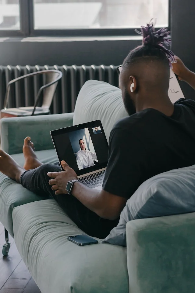 Man watching video using laptop.